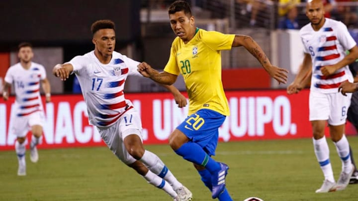 EAST RUTHERFORD, NJ - SEPTEMBER 07: Roberto Firmino #20 of Brazil drives by Antonee Robinson #17 of the USA during their friendly match at MetLife Stadium on September 7, 2018 in East Rutherford, New Jersey. (Photo by Jeff Zelevansky/Getty Images)