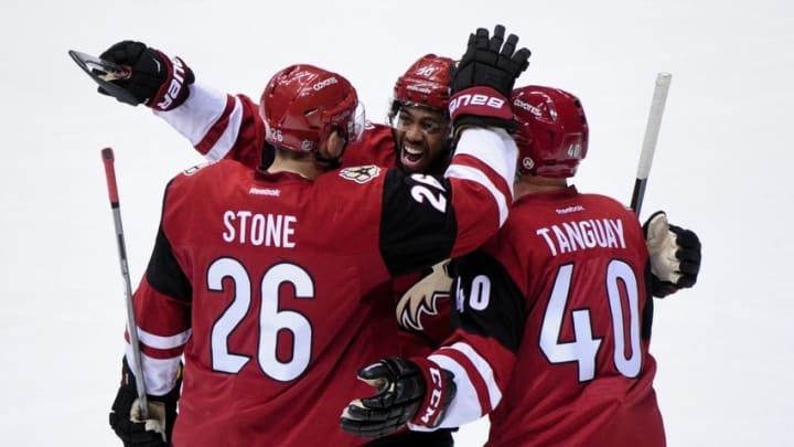 Mar 17, 2016; Glendale, AZ, USA; Arizona Coyotes defenseman Michael Stone (26) celebrates with left wing Anthony Duclair (10) and left wing Alex Tanguay (40) after scoring a goal in the first period against the San Jose Sharks at Gila River Arena. Mandatory Credit: Matt Kartozian-USA TODAY Sports