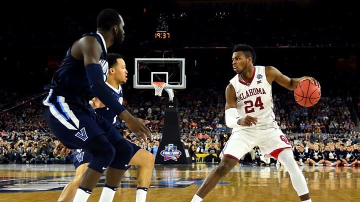 Apr 2, 2016; Houston, TX, USA; Oklahoma Sooners guard Buddy Hield (24) handles the ball against Villanova Wildcats forward Daniel Ochefu (23) during the second half in the 2016 NCAA Men