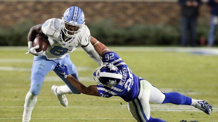 Nov 10, 2016; Durham, NC, USA; North Carolina Tar Heels is tackled by Duke Blue Devils safety Corbin McCarthy (26) in the second half of their game at Wallace Wade Stadium. Mandatory Credit: Mark Dolejs-USA TODAY Sports