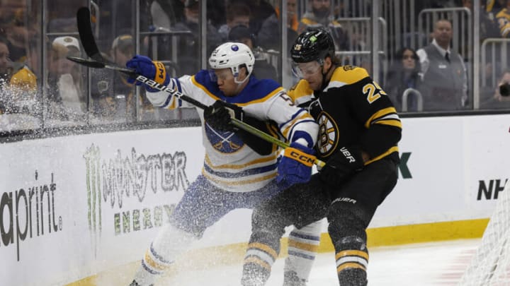 Mar 2, 2023; Boston, Massachusetts, USA; Boston Bruins defenseman Brandon Carlo (25) rides Buffalo Sabres left wing Jeff Skinner (53) into the boards during the second period at TD Garden. Mandatory Credit: Winslow Townson-USA TODAY Sports