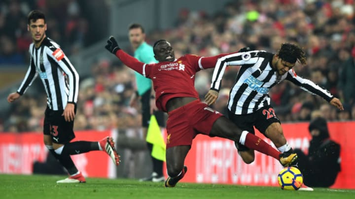 LIVERPOOL, ENGLAND - MARCH 03: Deandre Yedlin of Newcastle United is tackled by Sadio Mane of Liverpool during the Premier League match between Liverpool and Newcastle United at Anfield on March 3, 2018 in Liverpool, England. (Photo by Gareth Copley/Getty Images)