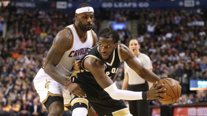 Nov 25, 2015; Toronto, Ontario, CAN; Toronto Raptors forward DeMarre Carroll (5) is guarded by Cleveland Cavaliers LeBron James (23) at Air Canada Centre. The Raptors beat the Cavaliers 103-99. Mandatory Credit: Tom Szczerbowski-USA TODAY Sports