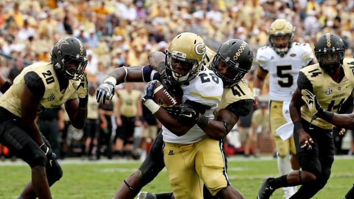 Sep 17, 2016; Atlanta, GA, USA; Georgia Tech Yellow Jackets running back Dedrick Mills (26) scores a rushing touchdown against Vanderbilt Commodores linebacker Zach Cunningham (41) in the third quarter of their game at Bobby Dodd Stadium. The Yellow Jackets won 38-7. Mandatory Credit: Jason Getz-USA TODAY Sports