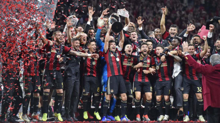 ATLANTA, GA - DECEMBER 08: Atlanta United players celebrate with the Philip F. Anschutz Trophy after winning the MLS Cup against the Portland Timbers at Mercedes-Benz Stadium in Atlanta, GA. Atlanta won 2-0. (Photo by Austin McAfee/Icon Sportswire via Getty Images)