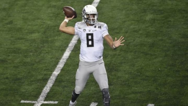 Jan 12, 2015; Arlington, TX, USA; Oregon Ducks quarterback Marcus Mariota (8) passes during the second quarter against the Ohio State Buckeyes in the 2015 CFP National Championship Game at AT&T Stadium. Mandatory Credit: Jerome Miron-USA TODAY Sports