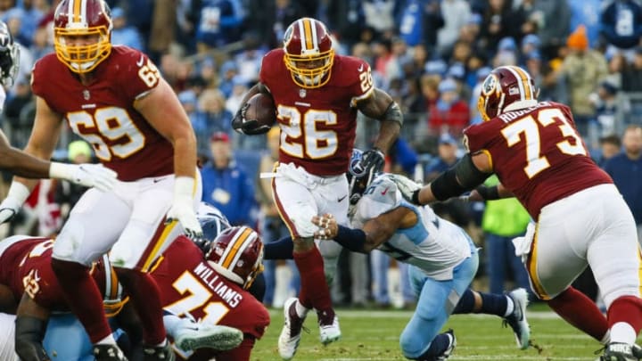 NASHVILLE, TN - DECEMBER 22: Adrian Peterson #26 of the Washington Redskins is defended by Rashaan Evans #54 of the Tennessee Titans while running with the ball during the second quarter at Nissan Stadium on December 22, 2018 in Nashville, Tennessee. (Photo by Frederick Breedon/Getty Images)