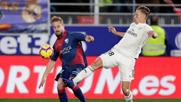 HUESCA, SPAIN - DECEMBER 9: (L-R) Jorge Pulido of SD Huesca, Marcos Llorenta of Real Madrid during the La Liga Santander match between SD Huesca v Real Madrid at the Estadio El Alcoraz on December 9, 2018 in Huesca Spain (Photo by Jeroen Meuwsen/Soccrates/Getty Images)
