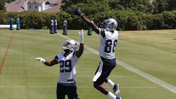 June 11, 2013; Irving, TX, USA; Dallas Cowboys receiver Dez Bryant (88) makes a catch against running back DeMarco Murray (29) during minicamp at Dallas Cowboys Headquarters. Mandatory Credit: Matthew Emmons-USA TODAY Sports