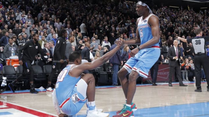 SACRAMENTO, CA - MARCH 1: De'Aaron Fox #5 of the Sacramento Kings helps Harrison Barnes #40 of the Sacramento Kings to his feet against the LA Clippers on March 1, 2019 at Golden 1 Center in Sacramento, California. NOTE TO USER: User expressly acknowledges and agrees that, by downloading and or using this Photograph, user is consenting to the terms and conditions of the Getty Images License Agreement. Mandatory Copyright Notice: Copyright 2019 NBAE (Photo by Rocky Widner/NBAE via Getty Images)
