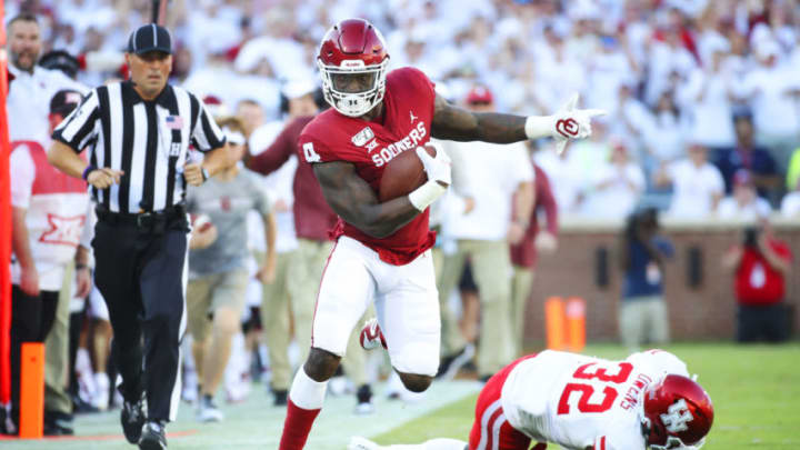 Sep 1, 2019; Norman, OK, USA; Oklahoma Sooners running back Trey Sermon (4) runs past Houston Cougars safety Gervarrius Owens (32) during the game against the Houston Cougars at Gaylord Family - Oklahoma Memorial Stadium. Mandatory Credit: Kevin Jairaj-USA TODAY Sports