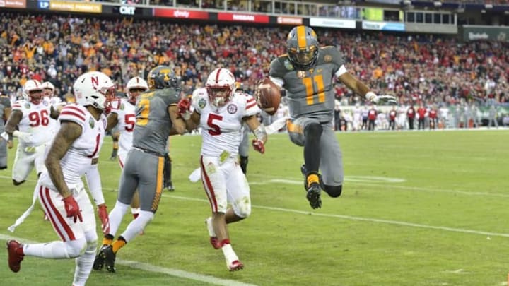 Dec 30, 2016; Nashville , TN, USA; Tennessee Volunteers quarterback Joshua Dobbs (11) scores a touchdown in the fourth quarter against the Nebraska Cornhuskers during the second half at Nissan Stadium. The Volunteers won 38-24. Mandatory Credit: Jim Brown-USA TODAY Sports