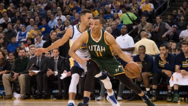 December 20, 2016; Oakland, CA, USA; Utah Jazz guard Dante Exum (11) dribbles the basketball against Golden State Warriors guard Stephen Curry (30) during the third quarter at Oracle Arena. The Warriors defeated the Jazz 104-74. Mandatory Credit: Kyle Terada-USA TODAY Sports