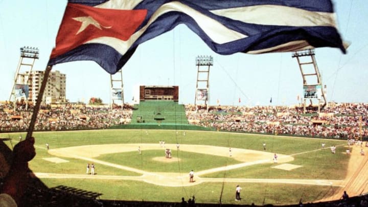 A Cuban fan waves the Cuban flag during the historic baseball game between the Baltimore Orioles and the Cuban national team at LatinoAmericano Stadium in Havana, Cuba 28 March, 1999. The Baltimore Orioles won the contest in 3-2 in eleven innings. AFP PHOTO/Adalberto ROQUE (Photo by Adalberto ROQUE / AFP) (Photo by ADALBERTO ROQUE/AFP via Getty Images)