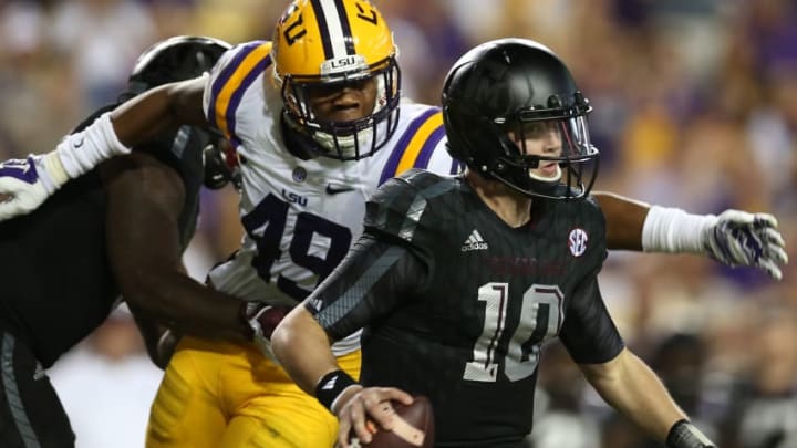 BATON ROUGE, LA - NOVEMBER 28: Kyle Allen #10 of the Texas A&M Aggies avoids a tackle by Arden Key #49 of the LSU Tigers at Tiger Stadium on November 28, 2015 in Baton Rouge, Louisiana. (Photo by Chris Graythen/Getty Images)