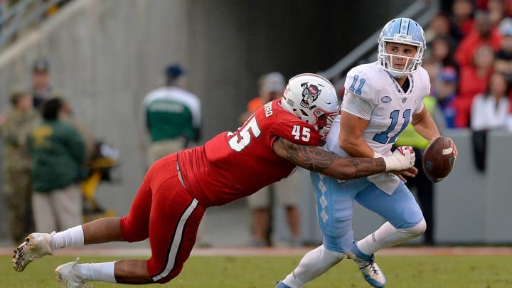 RALEIGH, NC – NOVEMBER 25: Darian Roseboro #45 of the North Carolina State Wolfpack sacks Nathan Elliott #11 of the North Carolina Tar Heels during their game at Carter Finley Stadium on November 25, 2017 in Raleigh, North Carolina. (Photo by Grant Halverson/Getty Images)