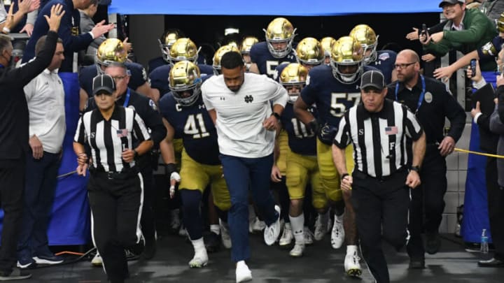 GLENDALE, ARIZONA - JANUARY 01: Head coach Marcus Freeman of the Notre Dame Fighting Irish leads his team onto the field for the Play Station Fiesta Bowl against the Oklahoma State University Cowboys at State Farm Stadium on January 01, 2022 in Glendale, Arizona. (Photo by Norm Hall/Getty Images)