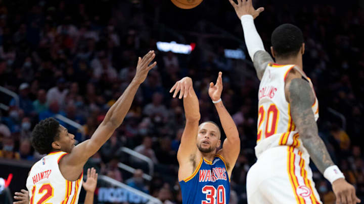November 8, 2021; San Francisco, California, USA; Golden State Warriors guard Stephen Curry (30) shoots the basketball against Atlanta Hawks forward De'Andre Hunter (12) and forward John Collins (20) during the fourth quarter at Chase Center. Mandatory Credit: Kyle Terada-USA TODAY Sports