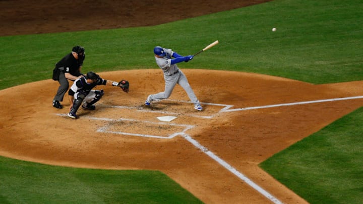 DENVER, CO - APRIL 7: David Freese #25 of the Los Angeles Dodgers hits an RBI double as catcher Chris Iannetta #22 of the Colorado Rockies and home plate umpire Bill Welke look on during the third inning at Coors Field on April 7, 2019 in Denver, Colorado. (Photo by Justin Edmonds/Getty Images)