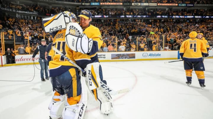 NASHVILLE, TN - MARCH 29: Pekka Rinne #35 congratulates Juuse Saros #74 of the Nashville Predators on a 5-3 win against the San Jose Sharks during an NHL game at Bridgestone Arena on March 29, 2018 in Nashville, Tennessee. (Photo by John Russell/NHLI via Getty Images)