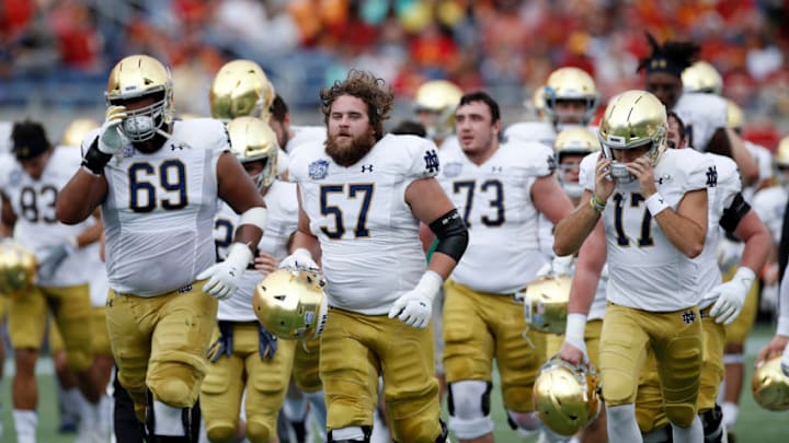 ORLANDO, FL - DECEMBER 28: Notre Dame Fighting Irish players head to the locker room after warming up prior to the Camping World Bowl against the Iowa State Cyclones at Camping World Stadium on December 28, 2019 in Orlando, Florida. Notre Dame defeated Iowa State 33-9. (Photo by Joe Robbins/Getty Images)