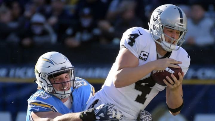 Dec 18, 2016; San Diego, CA, USA; Oakland Raiders quarterback Derek Carr (4) is sacked by San Diego Chargers defensive end Joey Bosa (99) during a NFL football game at Qualcomm Stadium. Mandatory Credit: Kirby Lee-USA TODAY Sports