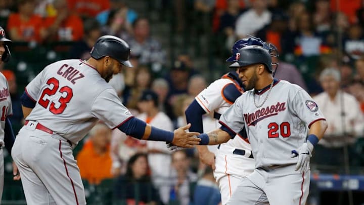 HOUSTON, TEXAS - APRIL 23: Eddie Rosario #20 of the Minnesota Twins receives congratulations from Nelson Cruz #23 after hitting a three run home run in the first inning against the Houston Astros at Minute Maid Park on April 23, 2019 in Houston, Texas. (Photo by Bob Levey/Getty Images)