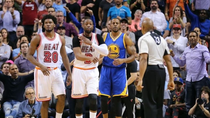 Feb 24, 2016; Miami, FL, USA; Miami Heat forward Justise Winslow (left) Miami Heat guard Dwyane Wade (center) and Golden State Warriors forward Andre Iguodala (right) react to a call from NBA referee Tre Maddox (73) during the first half at American Airlines Arena. Mandatory Credit: Steve Mitchell-USA TODAY Sports