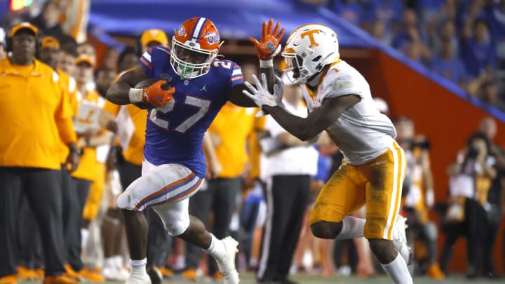 Sep 25, 2021; Gainesville, Florida, USA; Florida Gators running back Dameon Pierce (27) runs with the ball as Tennessee Volunteers defensive back Trevon Flowers (1) defends during the fourth quarter at Ben Hill Griffin Stadium. Mandatory Credit: Kim Klement-USA TODAY Sports
