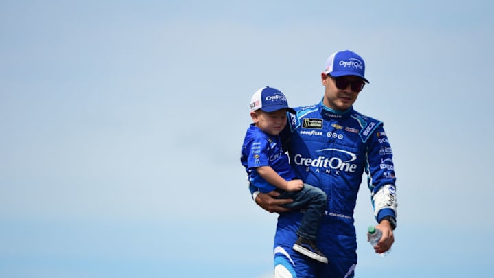 WATKINS GLEN, NY - AUGUST 06: Kyle Larson, driver of the #42 Credit One Bank Chevrolet, walks with his son Owen after being introduced prior to the Monster Energy NASCAR Cup Series I Love NY 355 at The Glen at Watkins Glen International on August 6, 2017 in Watkins Glen, New York. (Photo by Jared C. Tilton/Getty Images)