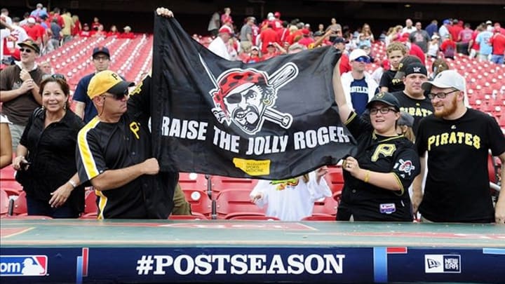 Oct 4, 2013; St. Louis, MO, USA; Fans of the Pittsburgh Pirates cheer and wave a flag after game two of the National League divisional series playoff baseball game against the St. Louis Cardinals at Busch Stadium. Mandatory Credit: Jeff Curry-USA TODAY Sports