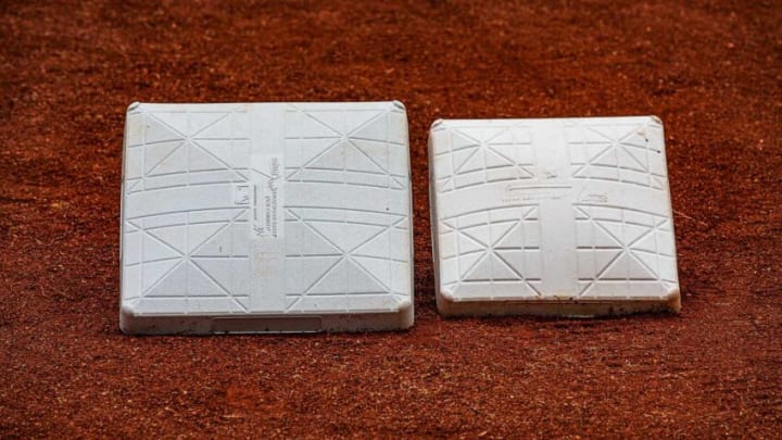 Bases sit side by side for size comparison in the dirt before a recent game at Louisville Slugger Field in Louisville, Ky. In an attempt to reduce player collisions and injuries, the size of the first, second and third bases in Triple-A was increased from 15 to 18 square inches.Jf Milb Bases 9x3a0593