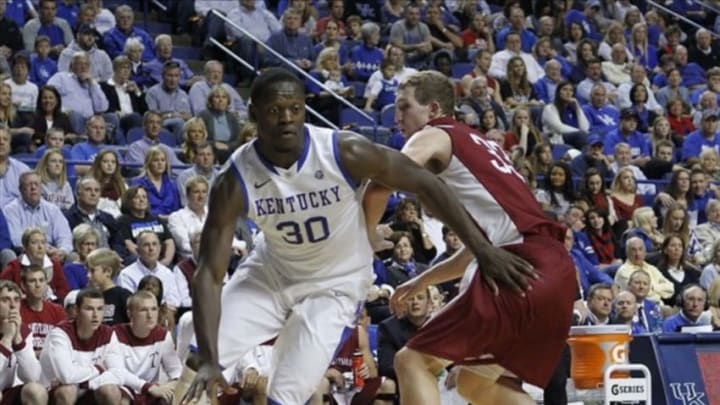 Nov 1, 2013; Lexington, KY, USA; Kentucky Wildcats forward Julius Randle (30) dribbles the ball around Transylvania Pioneers forward Chris Taylor (33) at Rupp Arena. Kentucky defeated Transylvania 76-42. Mandatory Credit: Mark Zerof-USA TODAY Sports