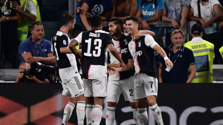 Juventus' Portuguese forward Cristiano Ronaldo (R) is congratulated by teammates after scoring a goal during the Italian Serie A football match Juventus vs Napoli on August 31, 2019 at the Juventus stadium in Turin. (Photo by Marco Bertorello / AFP) (Photo credit should read MARCO BERTORELLO/AFP via Getty Images)