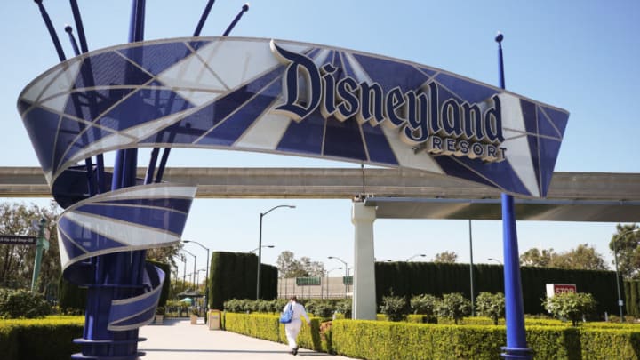 ANAHEIM, CALIFORNIA - SEPTEMBER 30: A person walks into an entrance to Disneyland on September 30, 2020 in Anaheim, California. Disney is laying off 28,000 workers amid the toll of the COVID-19 pandemic on theme parks. (Photo by Mario Tama/Getty Images)