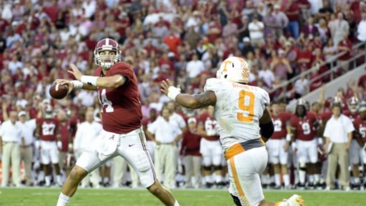 Oct 24, 2015; Tuscaloosa, AL, USA; Alabama Crimson Tide quarterback Jake Coker (14) rolls out to pass on a two point conversion against Tennessee Volunteers defensive end Derek Barnett (9) during the fourth quarter at Bryant-Denny Stadium. Mandatory Credit: John David Mercer-USA TODAY Sports