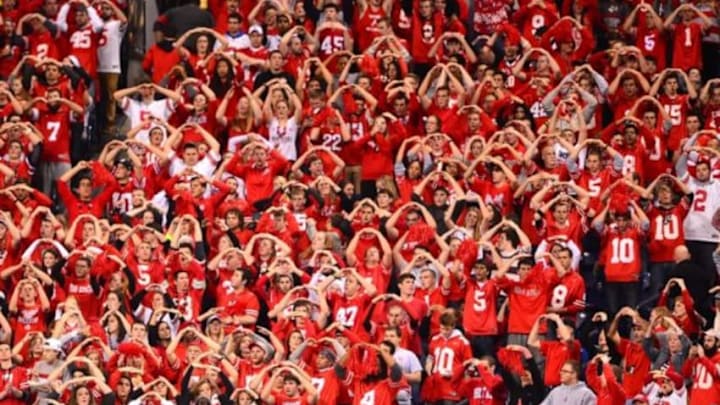 Dec 7, 2013; Indianapolis, IN, USA; Ohio State Buckeyes fans cheer during the third quarter of the 2013 Big 10 Championship game against the Michigan State Spartans at Lucas Oil Stadium. Mandatory Credit: Andrew Weber-USA TODAY Sports Dec 7, 2013; Indianapolis, IN, USA; Ohio State Buckeyes fans cheer during the third quarter of the 2013 Big 10 Championship game against the Michigan State Spartans at Lucas Oil Stadium. Mandatory Credit: Andrew Weber-USA TODAY Sports