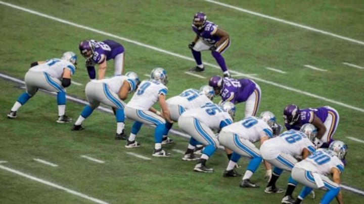 Dec 29, 2013; Minneapolis, MN, USA; Detroit Lions quarterback Matthew Stafford (9) lines up behind his offensive lineman on a play against the Minnesota Vikings in the fourth quarter at Mall of America Field at H.H.H. Metrodome. The Vikings win 14-13. Mandatory Credit: Bruce Kluckhohn-USA TODAY Sports