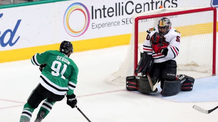 DALLAS, TX - DECEMBER 21: Corey Crawford #50 of the Chicago Blackhawks blocks a shot against Tyler Seguin #91 of the Dallas Stars in the third period at American Airlines Center on December 21, 2017 in Dallas, Texas. (Photo by Tom Pennington/Getty Images)