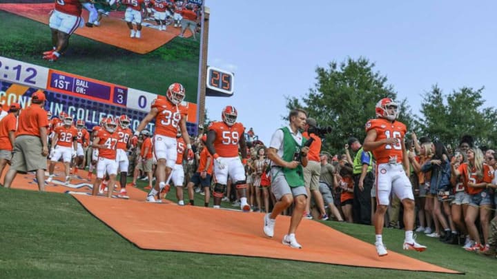Clemson quarterback Will Taylor (16) , right, runs down the hill with teammates before the game with South Carolina State University Saturday, September 11, 2021.Ncaa Football Clemson