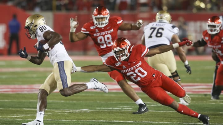 Nov 30, 2019; Houston, TX, USA;Navy Midshipmen wide receiver Mark Walker (80) carries the ball past Houston Cougars safety Jordan Moore (20) in the second half at TDECU Stadium. Mandatory Credit: Thomas B. Shea-USA TODAY Sports