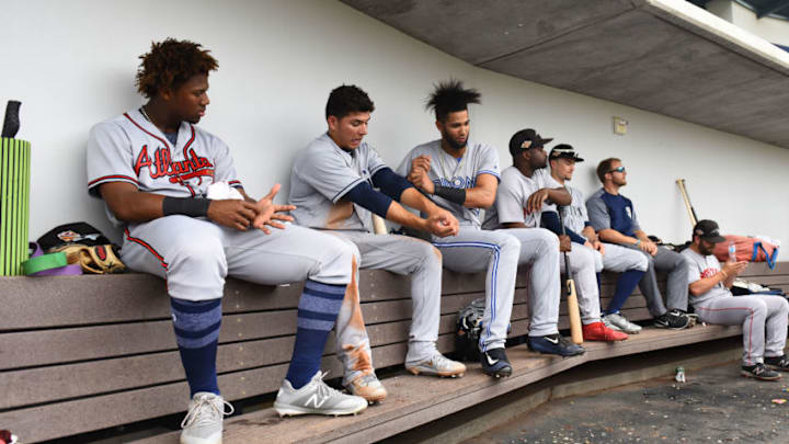 MESA, AZ - NOVEMBER 07: Ronald Acuna #34 (ATL), Luis Urias #9 (SD), Lourdes Gurriel #21 (TOR) and Josh Tobias #13 of Peoria Javelinas (BOS) sit in the dugout in the Arizona Fall League game against the Mesa Solar Sox at Sloan Park on November 11, 2017 in Mesa, Arizona. (Photo by Jennifer Stewart/Getty Images)