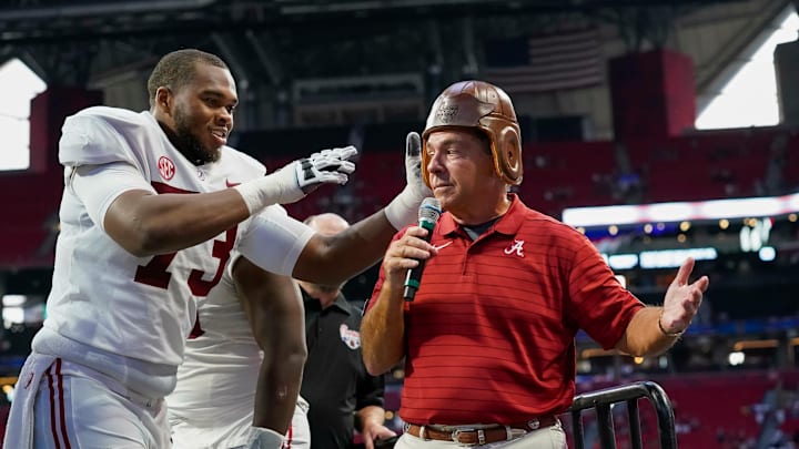 Sep 4, 2021; Atlanta, Georgia, USA; Alabama Crimson Tide offensive lineman Evan Neal (73) puts the Old Leather Helmet on head coach Nick Saban after Alabama defeated the Miami Hurricanes at Mercedes-Benz Stadium. Mandatory Credit: Dale Zanine-USA TODAY Sports