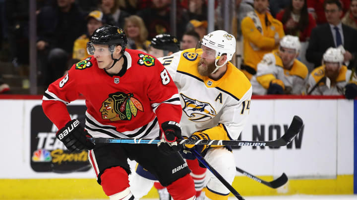 CHICAGO, ILLINOIS – FEBRUARY 21: Dominik Kubalik #8 of the Chicago Blackhawks and Mattias Ekholm #14 of the Nashville Predators (Photo by Jonathan Daniel/Getty Images)