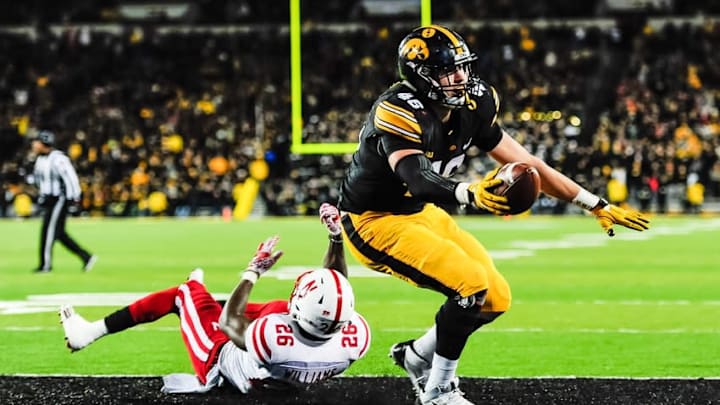 Nov 25, 2016; Iowa City, IA, USA; Iowa Hawkeyes tight end George Kittle (46) scores on a touchdown pass from quarterback C.J. Beathard (not pictured) as Nebraska Cornhuskers safety Kieron Williams (26) defends during the second half at Kinnick Stadium. Mandatory Credit: Jeffrey Becker-USA TODAY Sports