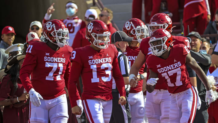 Nov 20, 2021; Norman, Oklahoma, USA; Oklahoma Sooners quarterback Caleb Williams (13) celebrates with teammates after scoring a touchdown during the first quarter against the Iowa State Cyclones at Gaylord Family-Oklahoma Memorial Stadium. Mandatory Credit: Kevin Jairaj-USA TODAY Sports