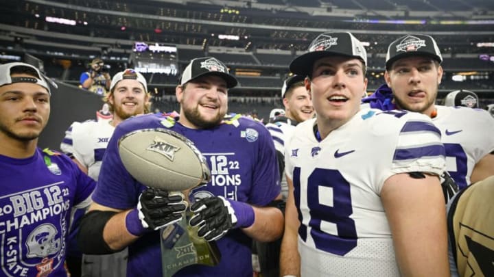 Dec 3, 2022; Arlington, TX, USA; Kansas State Wildcats quarterback Will Howard (18) and his teammates celebrate winning the Big 12 championship after defeating the TCU Horned Frogs in overtime at AT&T Stadium. Mandatory Credit: Jerome Miron-USA TODAY Sports