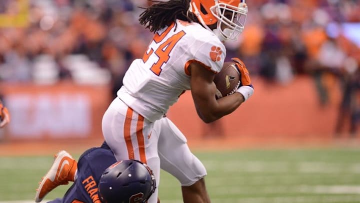 Nov 14, 2015; Syracuse, NY, USA; Clemson Tigers running back Zac Brooks (24) runs through the tackle of Syracuse Orange linebacker Zaire Franklin (4) during the fourth quarter of a game at the Carrier Dome. Mandatory Credit: Mark Konezny-USA TODAY Sports