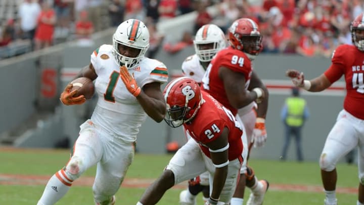 Nov 19, 2016; Raleigh, NC, USA; Miami Hurricanes running back Mark Walton (1) runs for a touchdown during the second half against the North Carolina State Wolfpack at Carter Finley Stadium. Miami won 27-13. Mandatory Credit: Rob Kinnan-USA TODAY Sports