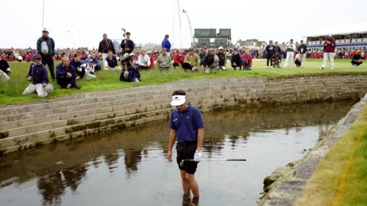 18 Jul 1999: Jean Van De Velde of France looks at his ball in the burn on the 18th hole during the British Open played at the Carnoustie GC in Carnoustie, Scotland. Mandatory Credit: Ross Kinnaird /Allsport